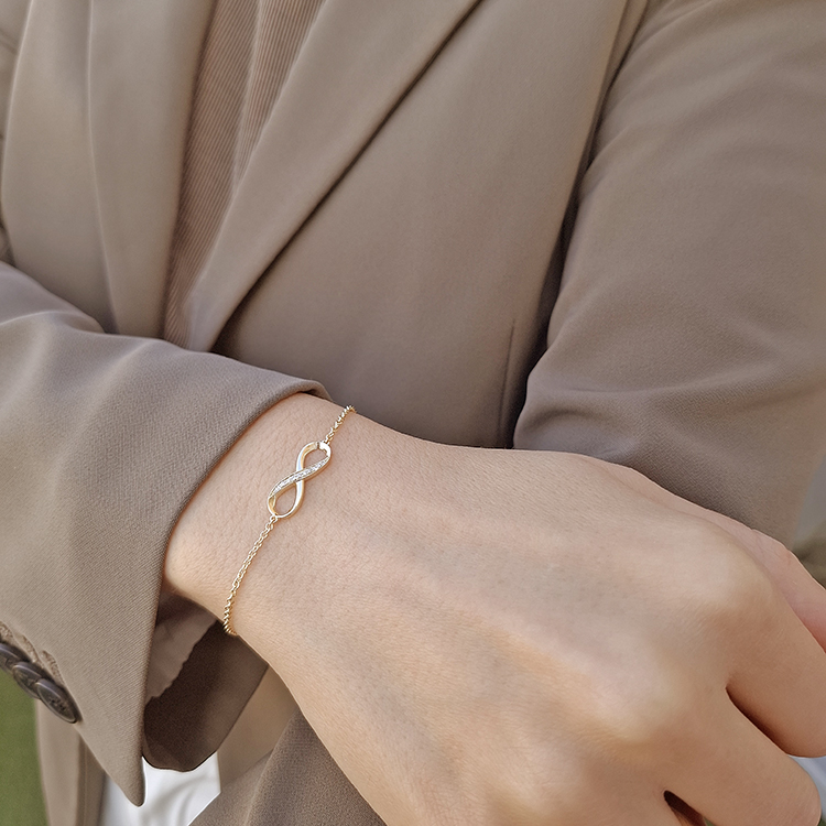 Realistic picture of Gold Infinity Bracelet with Natural Diamonds - A Symbol of Eternal Love